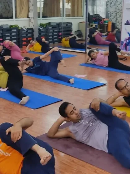 Students practicing Anantasana, the Sleeping Vishnu Pose. This pose is excellent for stretching the hamstrings and improving balance while lying on the side.