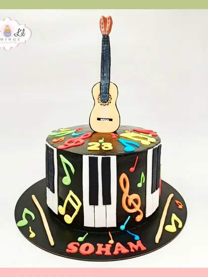 A musical cake for Soham's 23rd birthday, featuring a piano key design, a guitar topper, and colorful music notes.