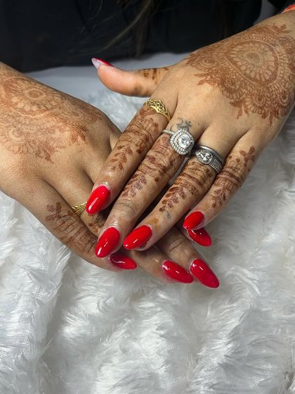 The almond shape of these acrylic extensions gives a very elegant look. The bright red gel polish is a timeless choice that brings a pop of color and confidence.