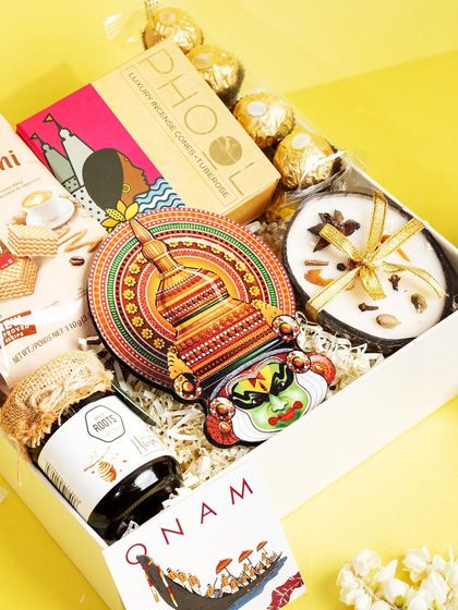 A detailed look inside the 'Jamanthi Poo' hamper, showing the arrangement of items like Phool incense, Ferrero Rocher, and a jar of honey.