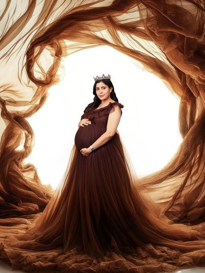 A dramatic and artistic portrait of a woman in a brown gown, enveloped in swirling brown fabric. The effect is powerful and elemental, like being at the heart of a beautiful storm.