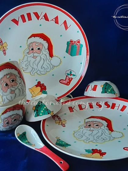 Deck the halls and their little table too! This festive Christmas dining set for kids is hand-painted with a cheerful Santa Claus theme and can be personalized with your child's name.