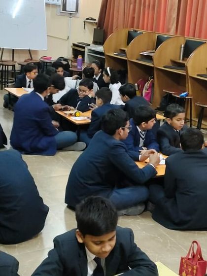 Our trainers guide students through every step. Here, an instructor assists a group of young learners as they navigate the complexities of their robotics project.