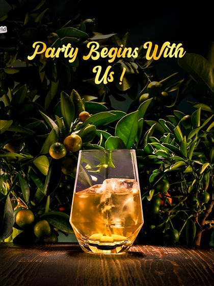 The party begins with us. A single, perfectly crafted cocktail in a lush, natural setting makes a bold statement: we are the starting point for any great celebration.