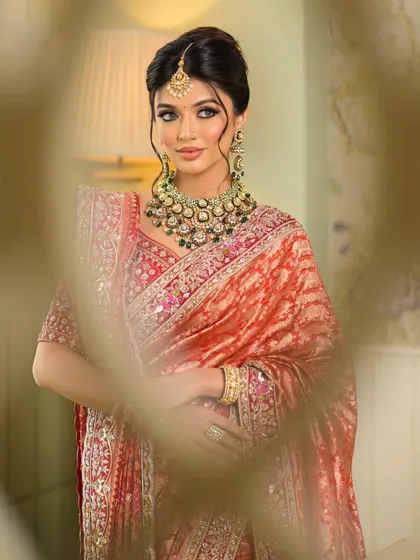 A soft, artistic shot that highlights the beauty of the bride and her exquisite saree.
