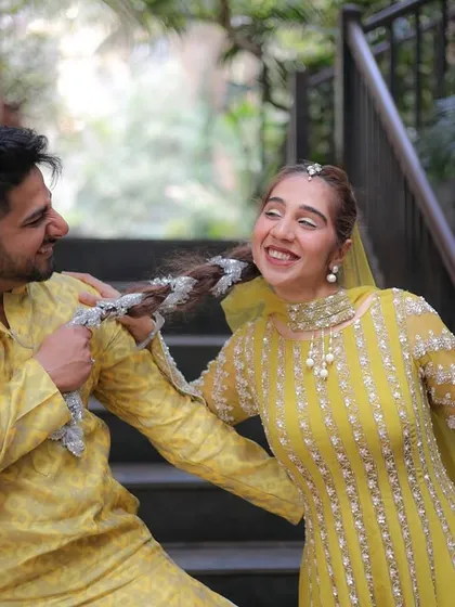 A playful moment between a brother and sister on her wedding day. Capturing these fun, candid family interactions is just as important as the main ceremony.