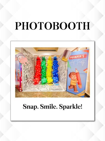 A closer look at the art party photobooth, designed to look like a giant coloring book page with colorful balloon "paint spills." It's an interactive and fun photo opportunity.