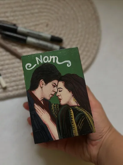 A close-up of the "Veer-Zaara" painting on the custom movie-themed pen stand.