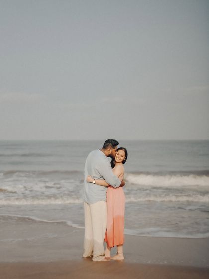 A tender moment between Anushka and Manu, with the vast ocean behind them. This image balances intimacy with the grand scale of the natural landscape.