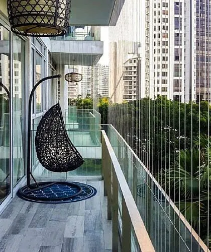 Your balcony can be both safe and stylish. Here you can see how my invisible grills blend seamlessly into a modern balcony design, featuring a comfortable swing chair. The slim profile of the grills ensures that your aesthetic is enhanced, not compromised.