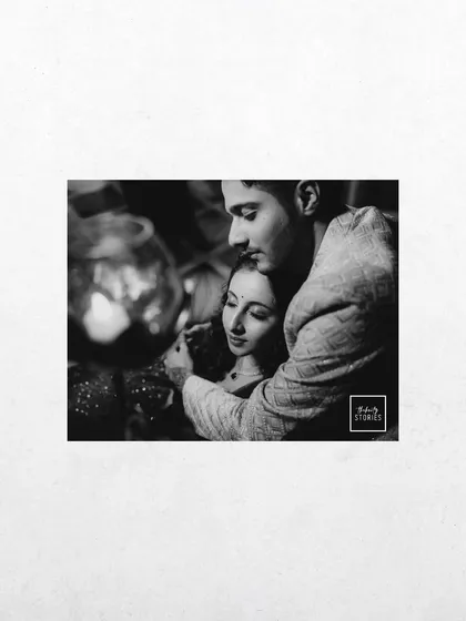 An intimate and artistic black and white close-up. The soft focus and tight crop draw all the attention to the couple's tender embrace.