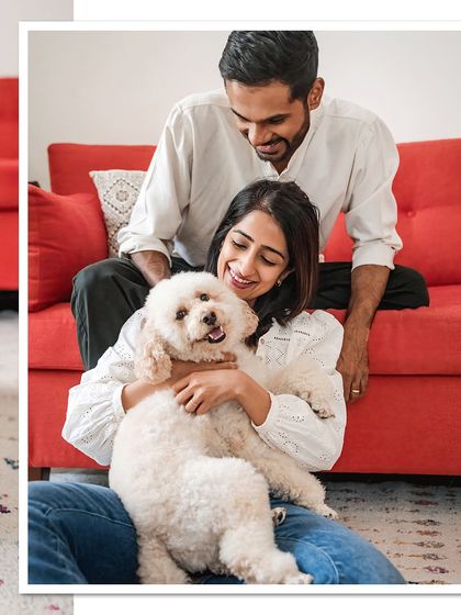 A classic family portrait with Dinkan and his parents. Everyone is smiling, creating a warm and inviting image of a happy family.