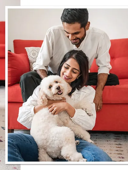 A classic family portrait with Dinkan and his parents. Everyone is smiling, creating a warm and inviting image of a happy family.