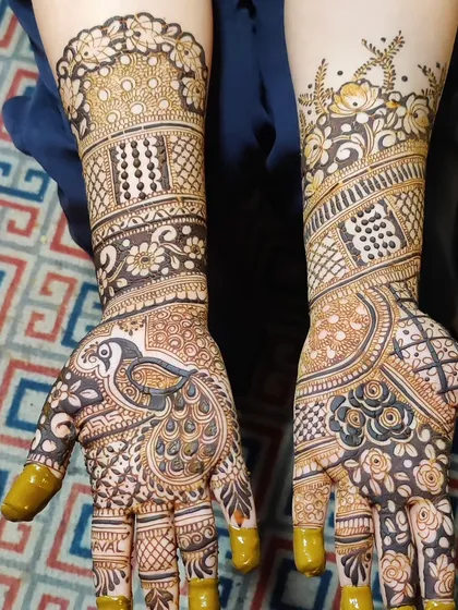 A full-hand design where the peacock is the star. The mix of fine lines and bold, filled sections makes the design stand out and ensures a deep henna stain.