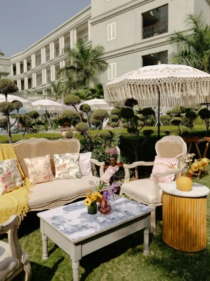 A charming lounge area at a Mehendi, featuring vintage-style furniture and macrame umbrellas. This setup was filled with personal details reflecting the couple's story.