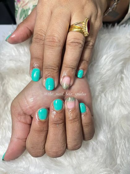 A close-up of the turquoise gel polish on natural nails. The color is vibrant and fresh, a great choice for anyone who loves a pop of color.