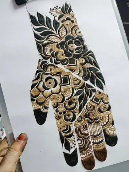 A striking design that uses both natural brown henna and a darker paste to create a two-tone effect. This adds incredible depth and contrast to the floral patterns.
