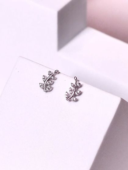 A closer look at our sparkling leaf-climber studs. These are designed to curve gracefully up the ear.