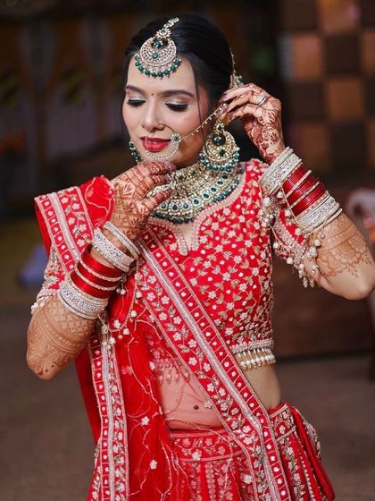 A final shot of the bride adjusting her jewellery, a perfect candid moment.