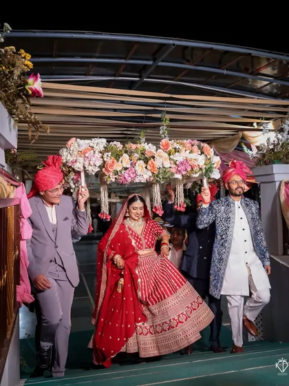 The bride's entry down the stairs, led by her brothers under a beautiful 'phoolon ki chadar'.