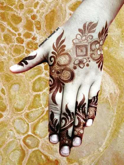 A bold and artistic design for the back of the hand. The use of negative space and strong lines makes this a real statement piece.