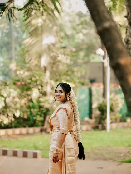 A view of the traditional South Indian bridal hairstyle, a long braid adorned with fresh jasmine flowers, which pairs beautifully with the classic makeup.