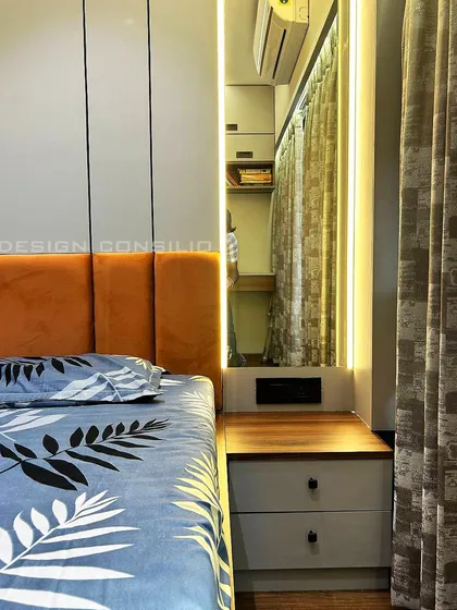This angle shows the custom dresser and mirror integrated next to the bed. The warm lighting around the mirror is perfect for getting ready and adds to the room's cozy ambiance.