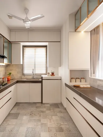 A full view of this modern white kitchen, designed for functionality and style. We used a mix of white cabinets, a patterned tile floor, and warm wood accents to create a bright and inviting atmosphere.