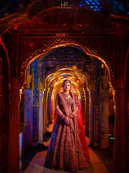 A bridal portrait should be as grand as the day itself. Here, I used the stunning architecture and dramatic lighting of the palace to frame the bride, making her look absolutely regal in her traditional red lehenga.
