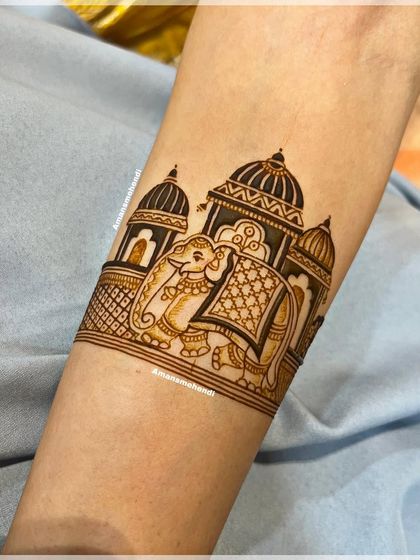 A close-up of a royal elephant in front of a palace. This arm band is the top section of a full bridal design, showcasing a classic and regal theme.