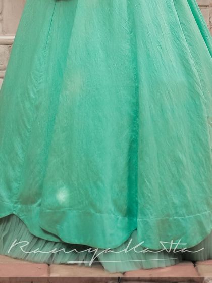 The layered tulle under the skirt adds volume and a dreamy quality to the turquoise lehenga.