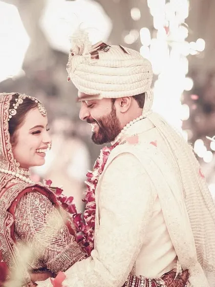 A happy, candid moment between the bride and groom during their varmala ceremony.