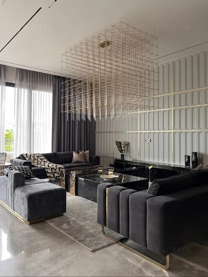 We designed these deep, channel-tufted sofas in a dark grey velvet to provide luxurious and comfortable seating. The geometric gold base adds a touch of our signature style, while the large grid chandelier creates a dramatic canopy overhead.