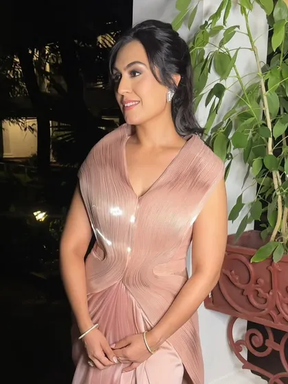 A candid moment showing off the beautiful profile and the elegant updo that complements this glamorous makeup.