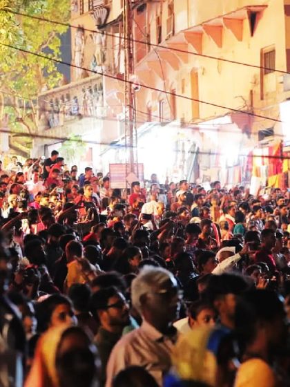 A wide shot of the massive crowd gathered at the ghats in Varanasi to witness our drone show. The sheer number of people shows the incredible draw of these unique cultural events.