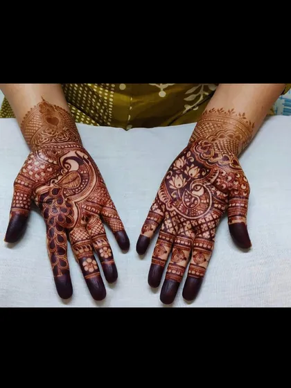 The beauty of a dark, mature henna stain. These hands showcase the rich color and intricate peacock designs a few days after application.