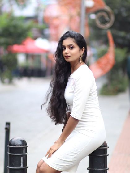 A classic seated portrait on a city street, capturing a timeless and elegant look.