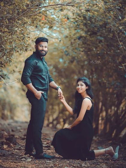 A beautiful portrait in the enchanted forest setting. The bride-to-be kneels while holding her partner's hand, creating a pose that is both respectful and romantic.