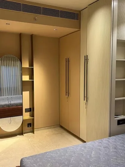 This wardrobe unit includes an integrated dressing mirror and open shelving. It’s a great example of how I design furniture that combines multiple functions into one seamless piece, saving space while adding style.