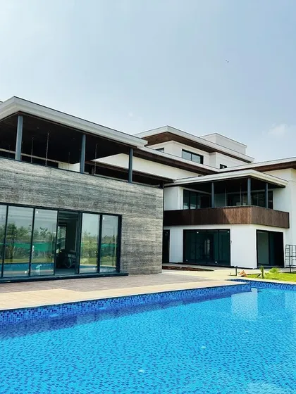 A wide view of a recently completed swimming pool for a modern residence. Our construction process ensures seamless integration with the property's architecture, creating a clean, expansive outdoor oasis perfect for relaxation and entertainment.