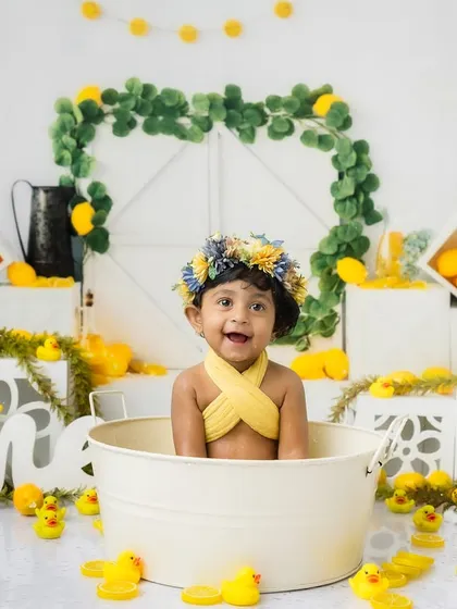 A wide shot of the complete lemon and ducky bath setup, showing the bright and cheerful scene I create for first birthday sessions.