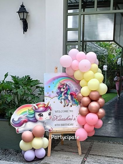 A close-up of the welcome sign, featuring a beautiful rainbow and unicorn graphic to greet the guests.