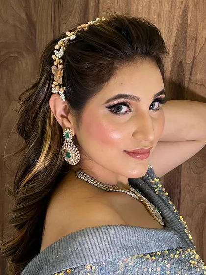 A side view of the half-up hairstyle, showing how the accessory is placed to create a beautiful focal point. The waves are kept loose and natural-looking.