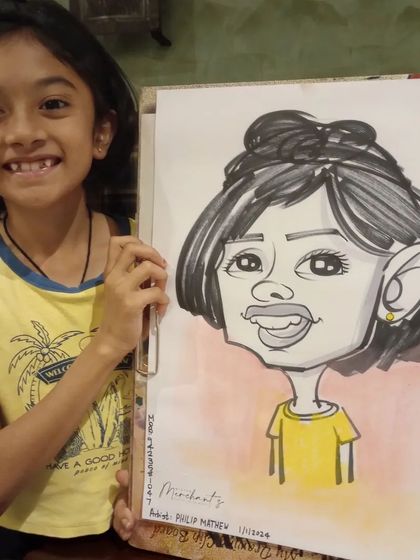 A young girl with her caricature. Her yellow shirt matches the warm tones in the drawing.