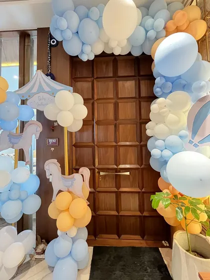 The whimsical theme extended to the entrance, with a beautiful balloon arch and hanging carousel horse cutouts to welcome guests into the celebration.