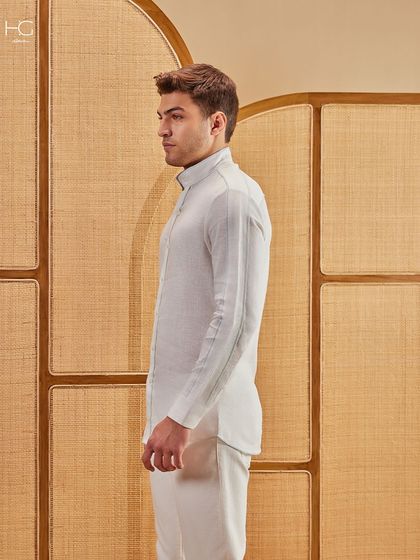 The side profile of the crisp white kurta, highlighting its perfect length and clean silhouette.