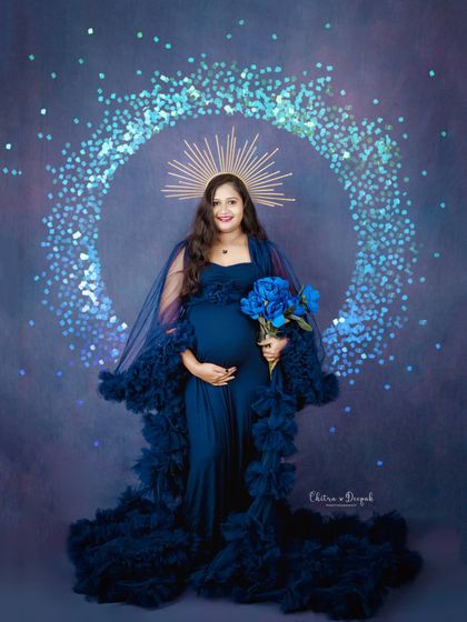 A divine look in navy blue. The sparkling halo and celestial backdrop elevate this portrait into a work of fine art.