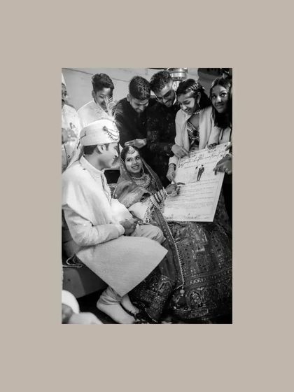 A fun, candid moment where the couple is presented with a signed contract by their friends during the ceremony.