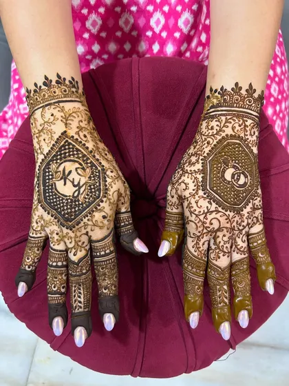 Perfect for an engagement or sangeet. This design features the couple's initials and wedding rings, framed by elegant geometric and floral patterns for a modern yet traditional look.