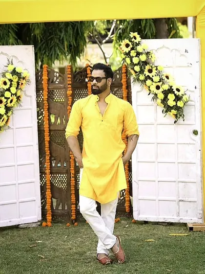 Rocking a bright yellow kurta for a daytime event. This traditional look is perfect for festive occasions like Haldi ceremonies or daytime parties.